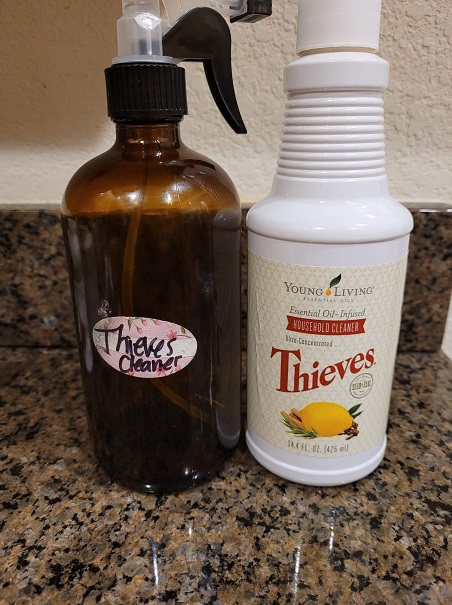 Thieves household cleaner concentrate and a diluted spray bottle