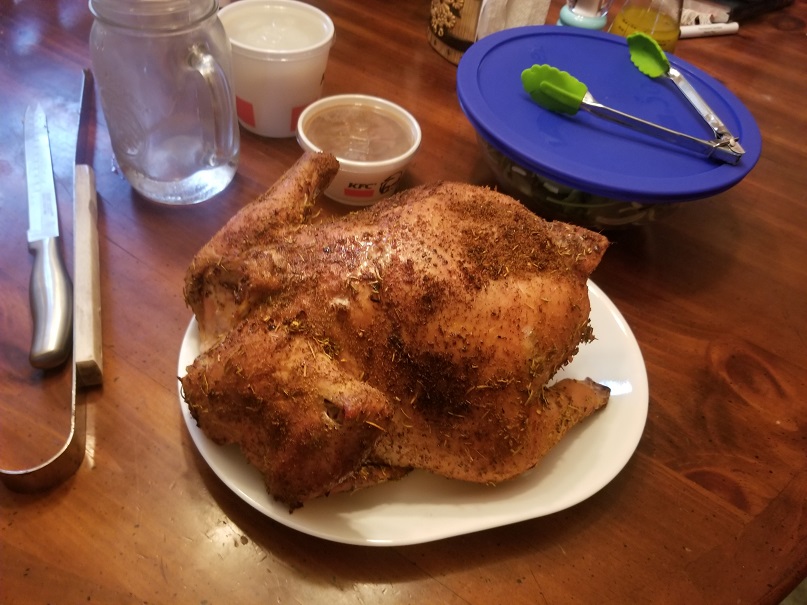 Smoked whole chicken with seasoning on a table