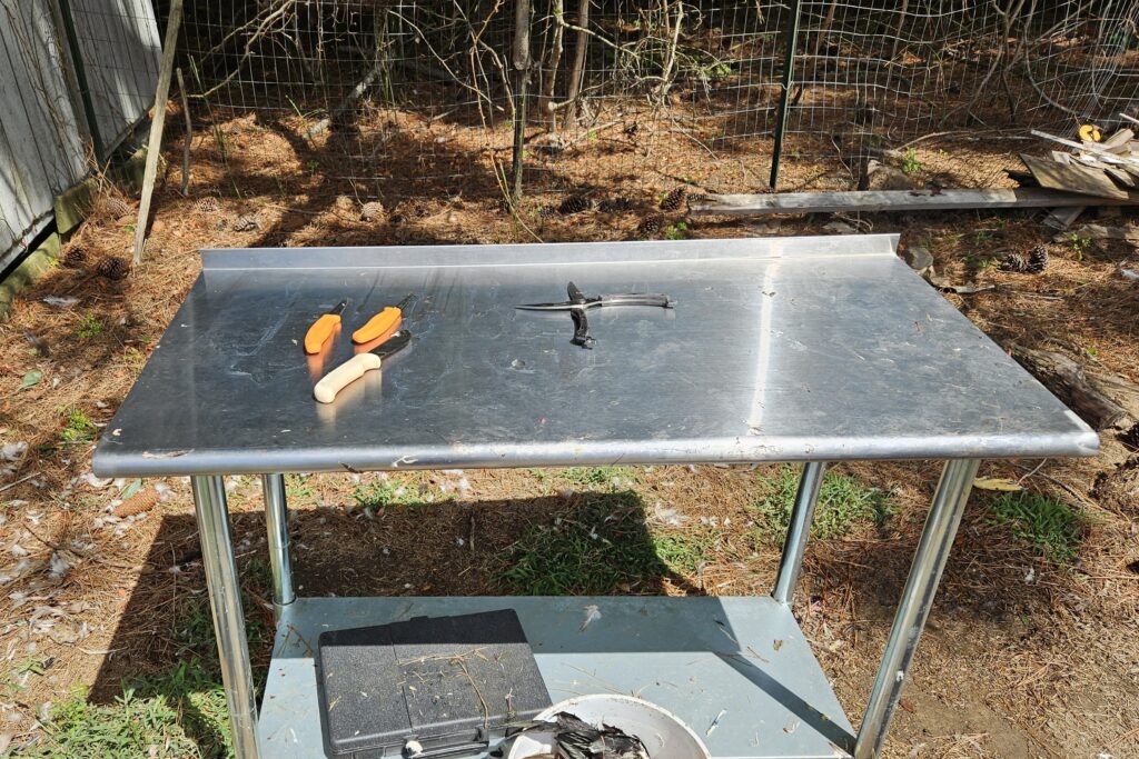 Stainless steel table with various knives on top